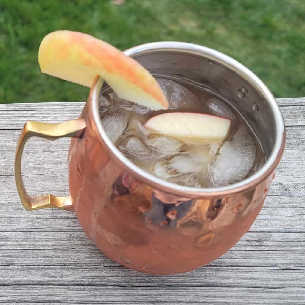 Apple Cider Moscow Mule with Apple Chunks in a copper mug