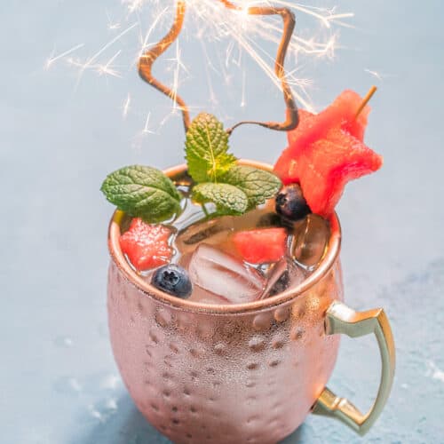 Watermelon Moscow Mule in a copper mug with a sparkler