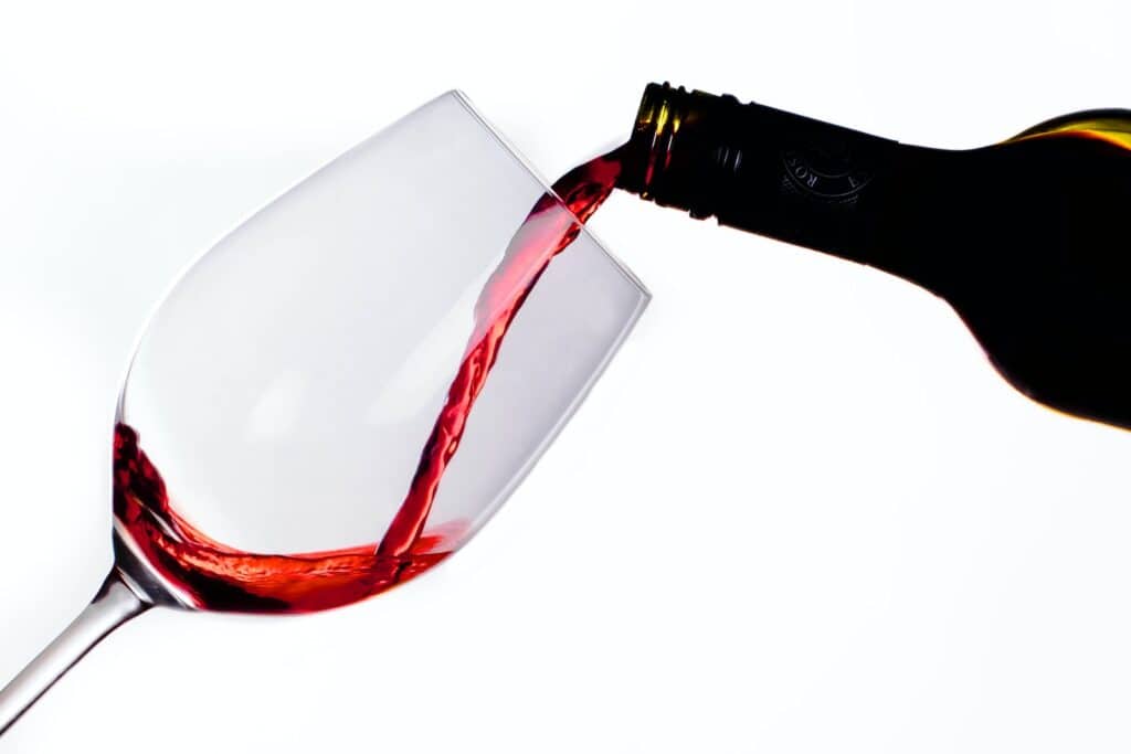 clear glass bottle with red wine