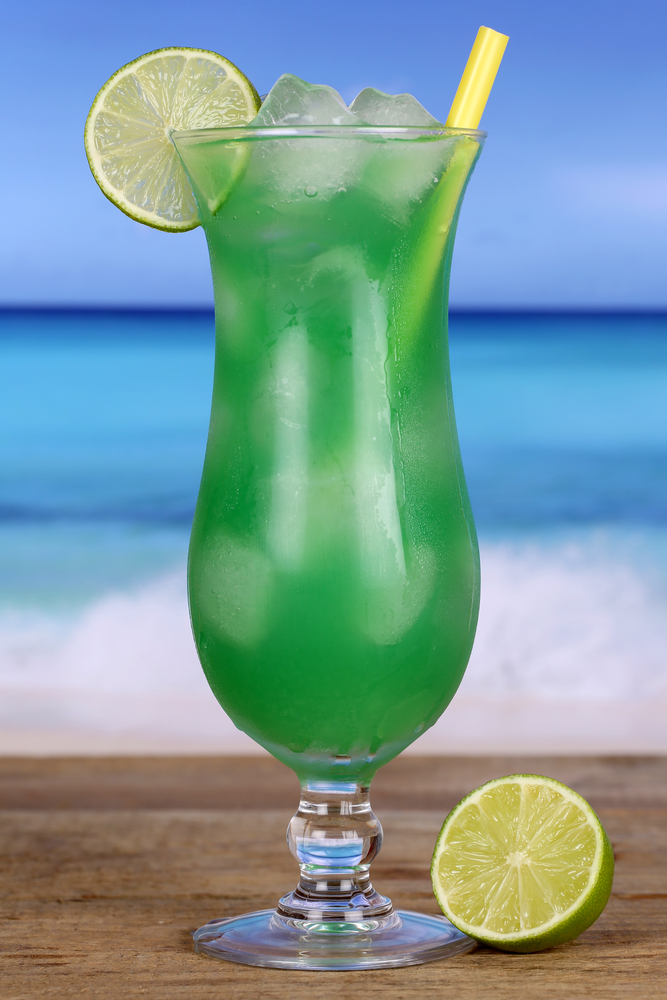 My Green Eyes Cocktail In a Hurricane Glass on a beach