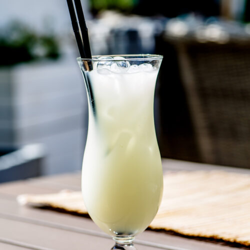 Virgin Pina Colada in a hurricane glass with a straw