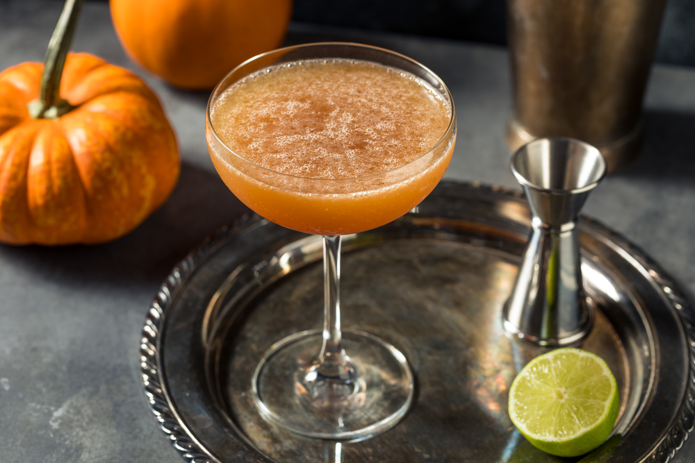 Pumpkin Spiced Margarita in a Coup glass on a silver tray.