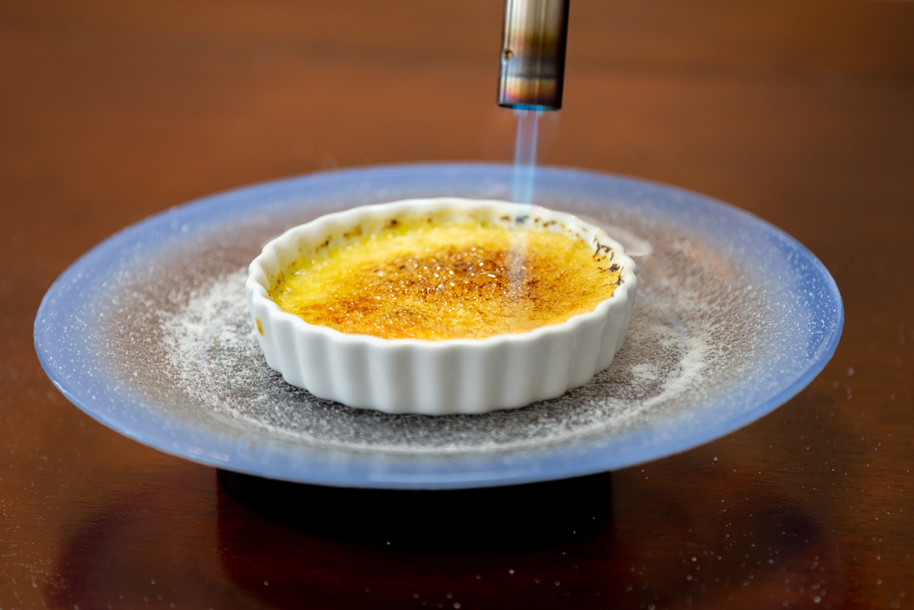 Creme Brulee being caramelized with a kitchen torch