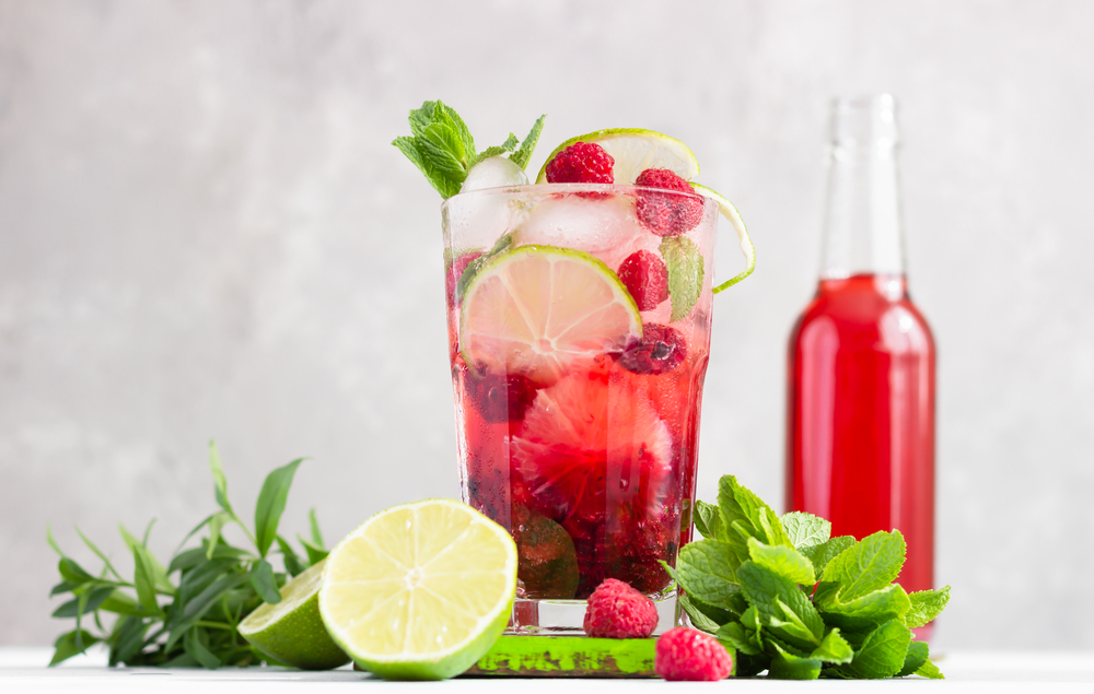 Delicious low sugar cocktails with muddled berries in a glass of club soda