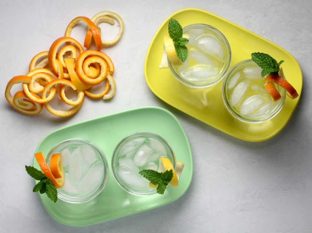 Orange and lemon citrus twist garnish in four glasses