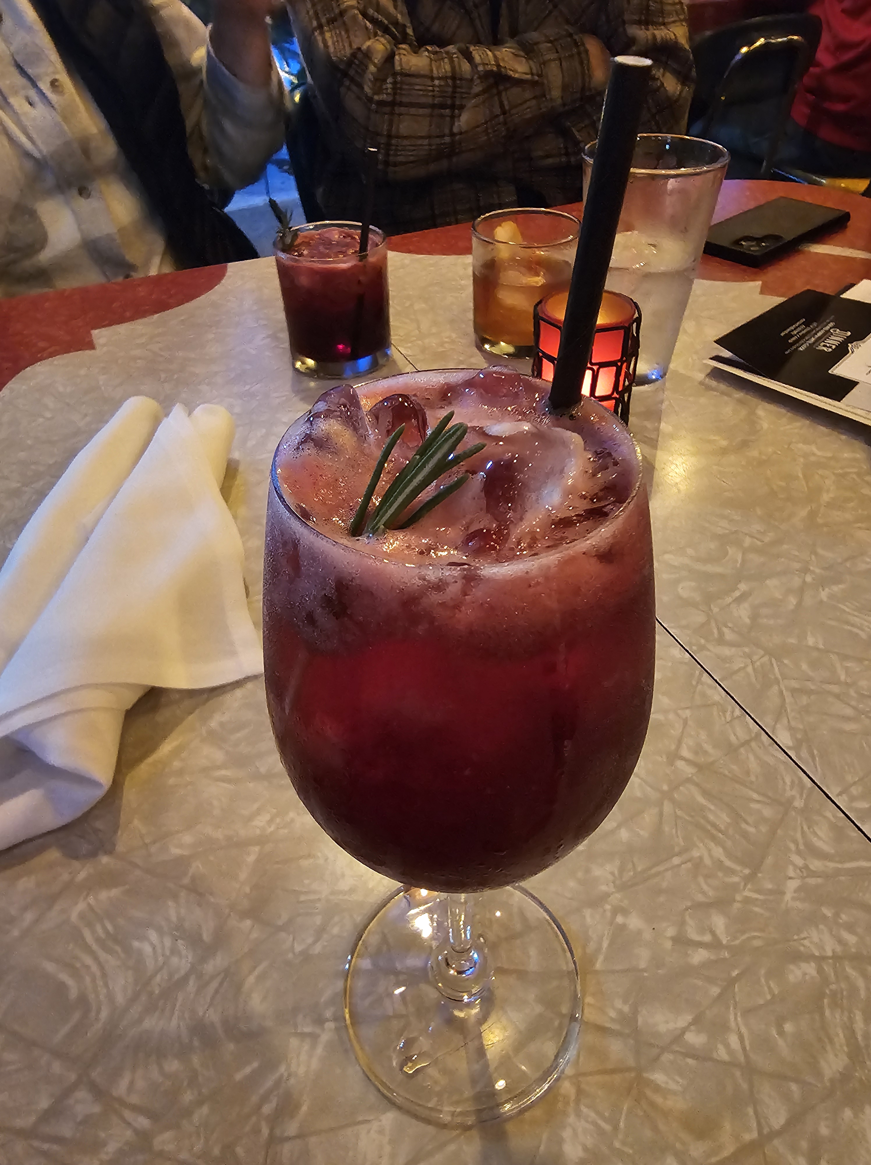 Prosecco cocktail with a sprig of rosemary in a wine glass