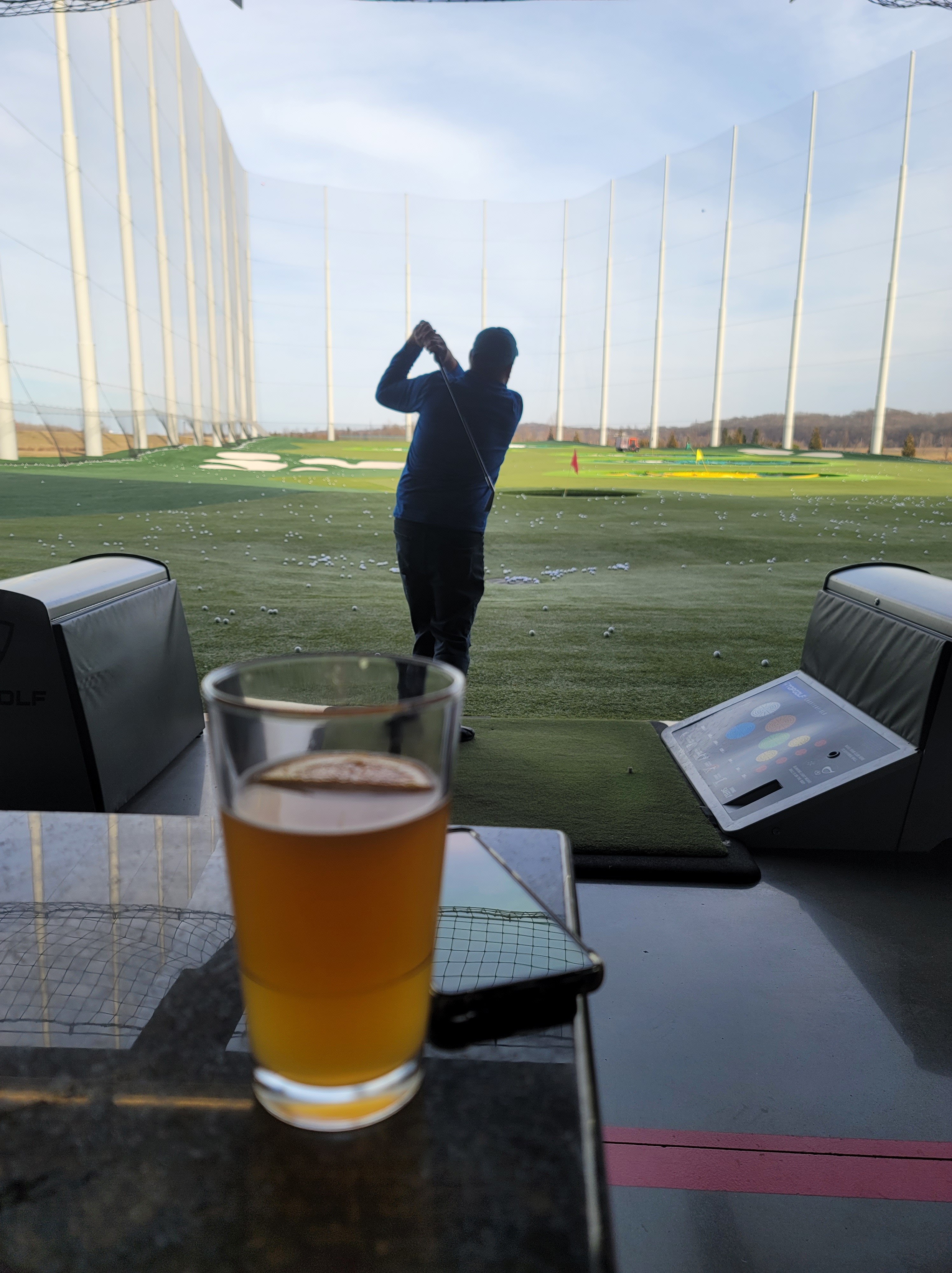 Top Golf bay with a Craft Beer
