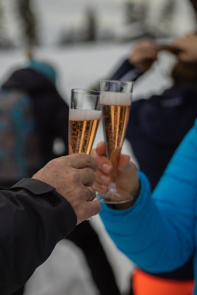 person holding clear drinking glass with Prosecco