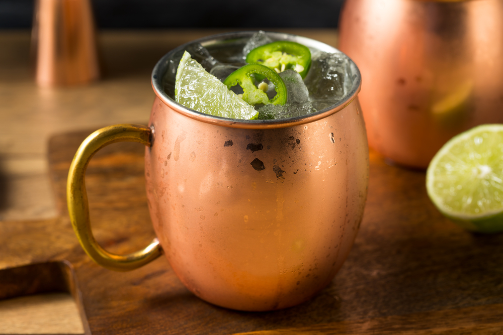 Cucumber Jalapeno Moscow Mule in a Copper Mule mug with slices of Jalapeno on top