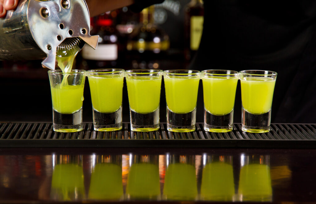 6 shot glasses filled with Green Tea Shots