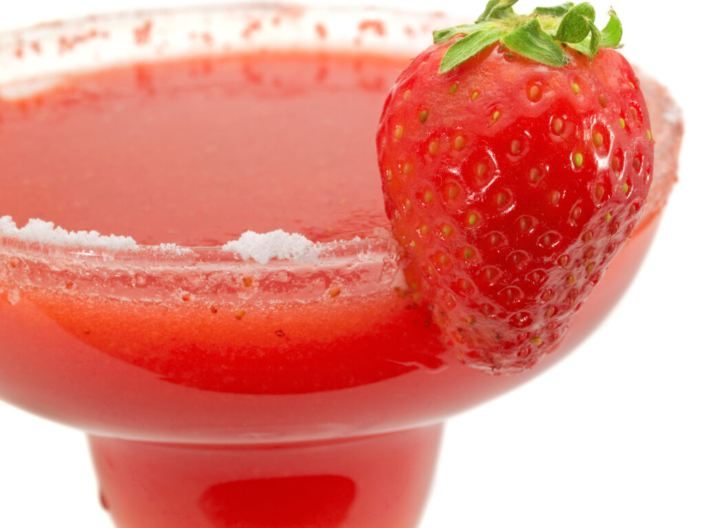 Galentine's Day Strawberry Margarita with salt and  a strawberry on rim