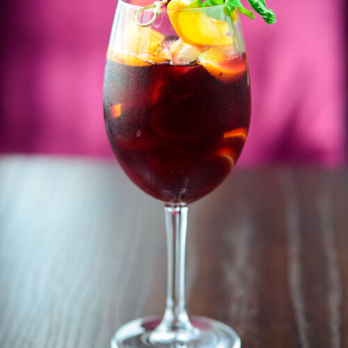 Irish Sangria in a wine glass with lemon and orange slices for garnish