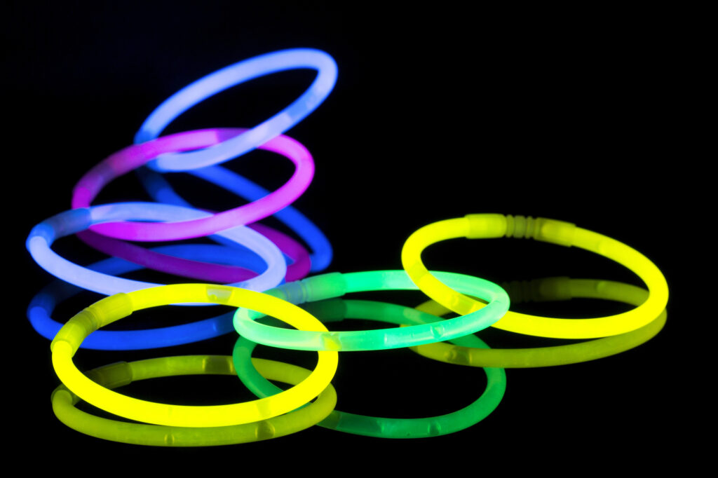 A bunch of glow sticks lit up against the darkness.