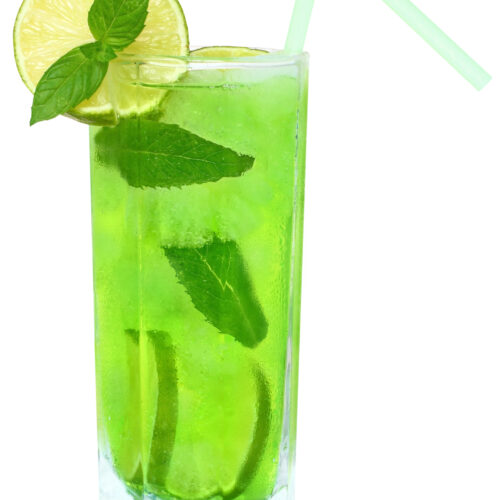 Green Leprechaun Luck Rum Punch in a tall glass with mint and lime