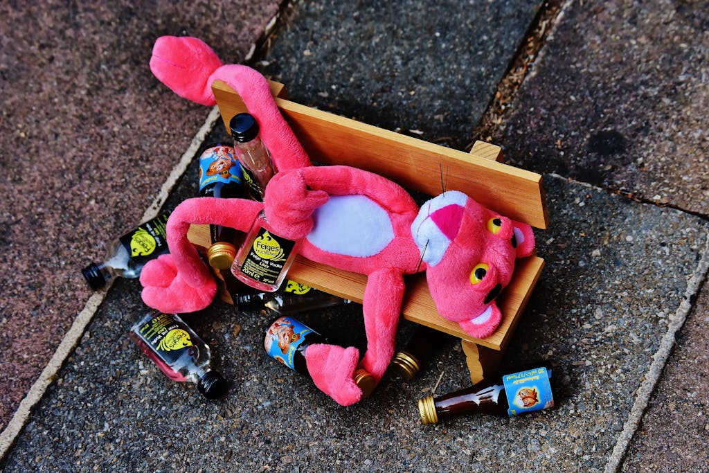 Pink Panther Plush Toy on Brown Bench Miniature