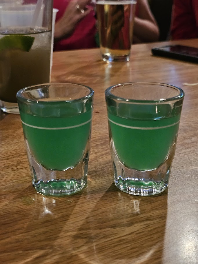 Two shot glasses filled with Liquid Marijuana Cocktail Shots