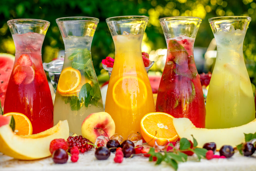 Five different pitchers of juice for a Mimosa Bar