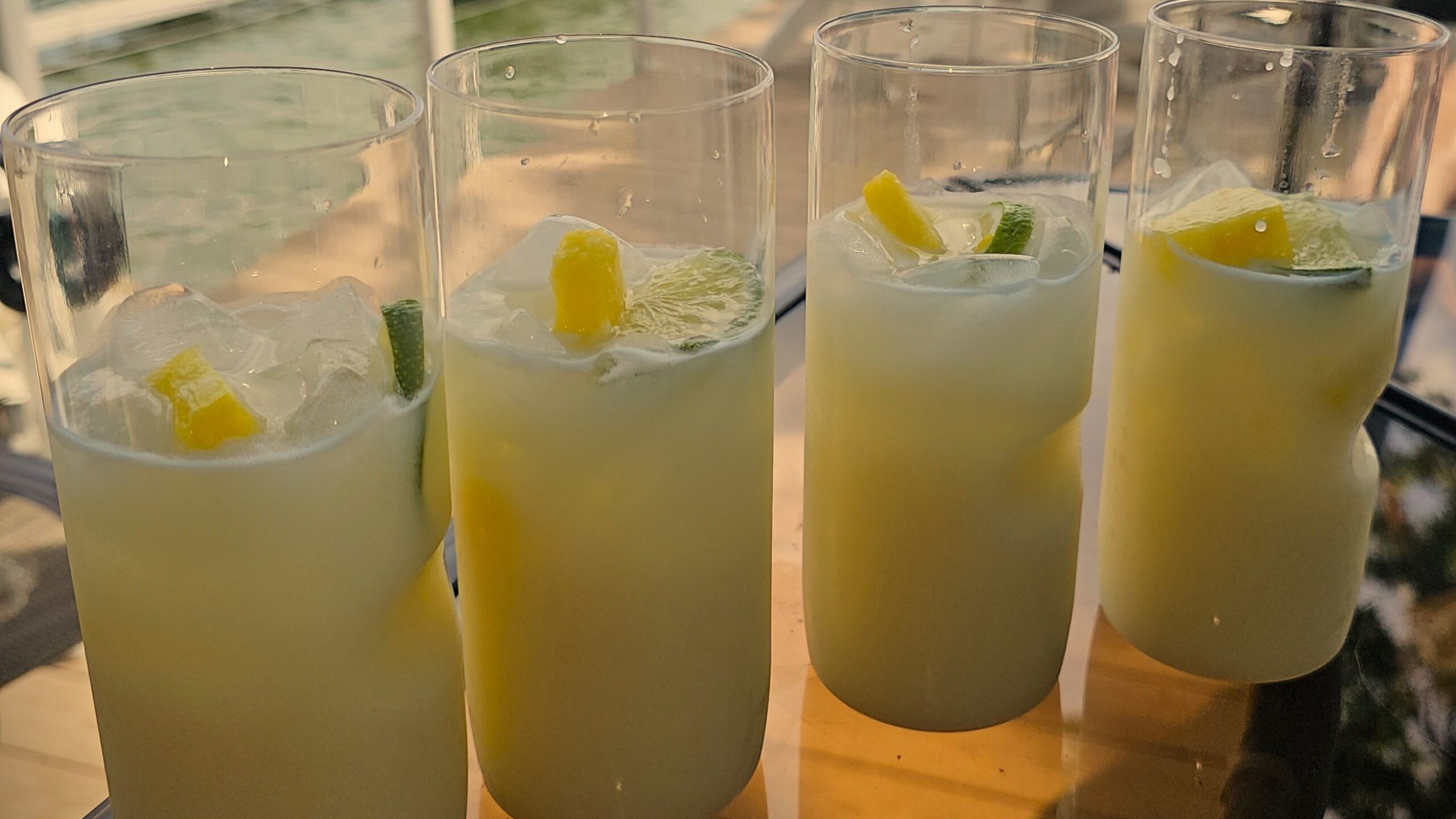 4 Glasses of Coconut Margarita with fresh pineapple and lime