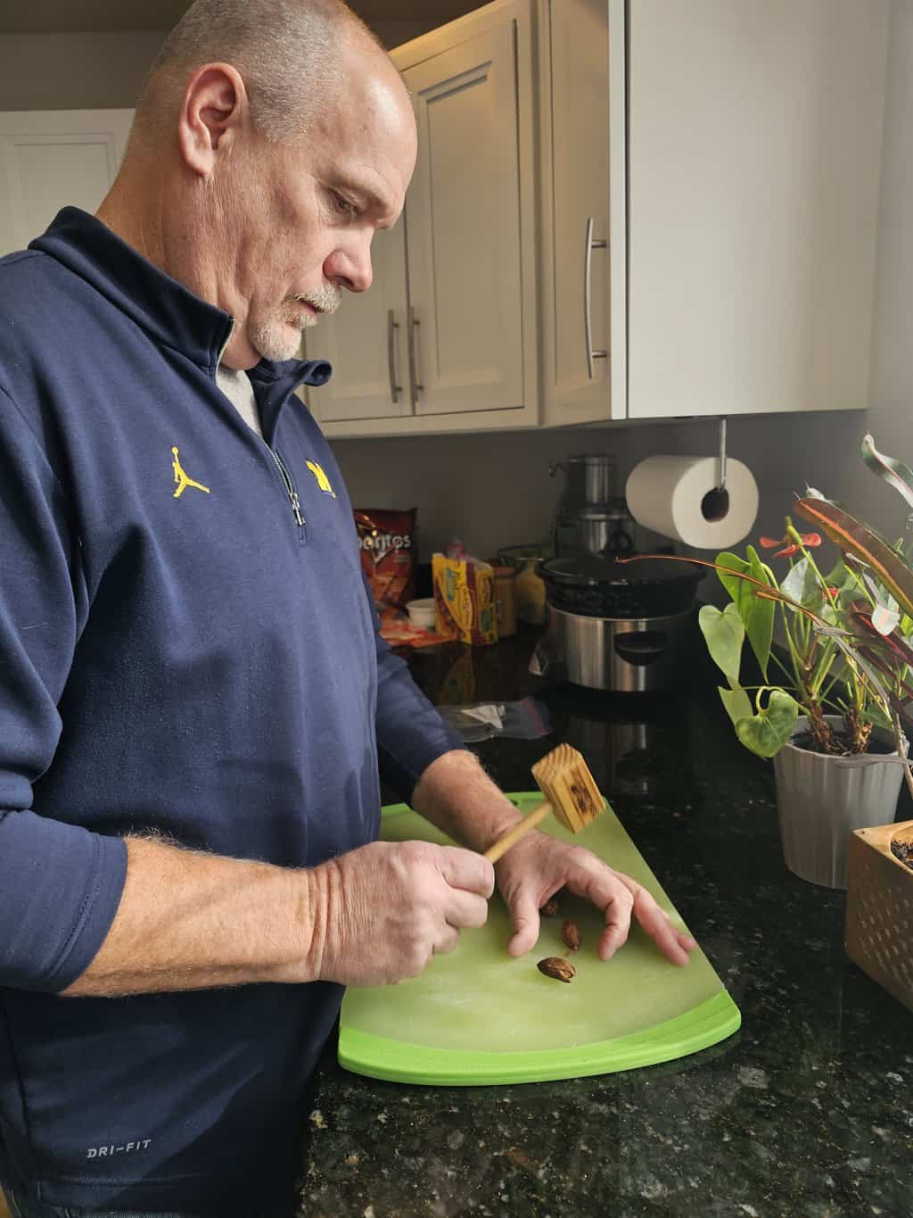 Man chopping ingredients on a cutting board