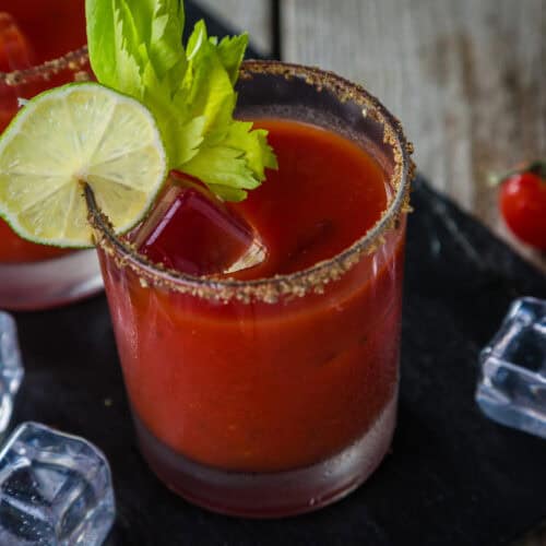 Spicy Bloody Mary with lime and celery and a spicy rim.