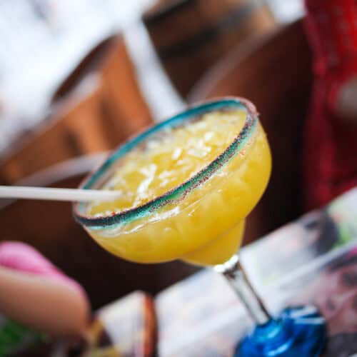 Mango Chili Margarita in a glass with a straw