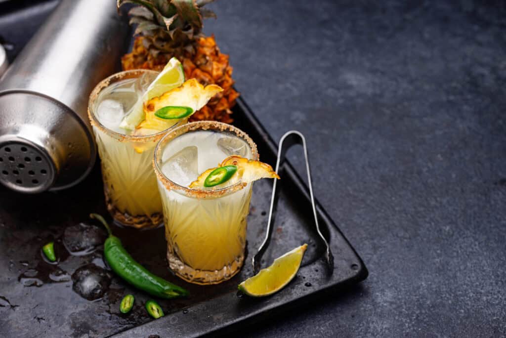 Pineapple Jalapeno Smash in two glasses on a tray