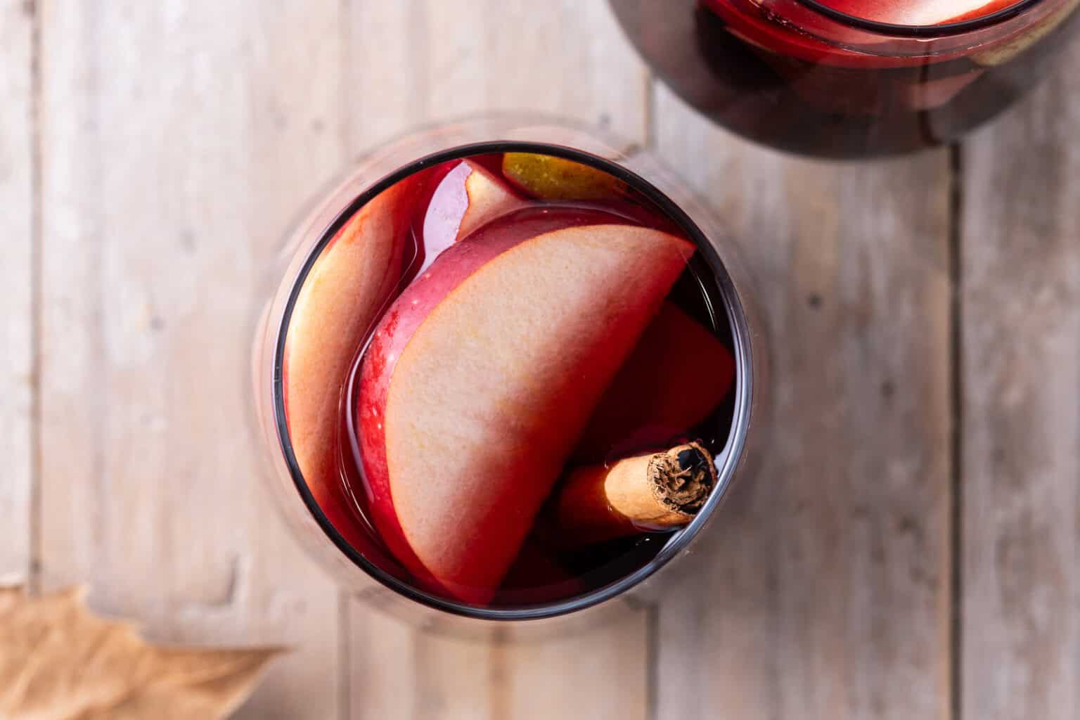 Red Cider Sangria with apple slices and a cinnamon stick