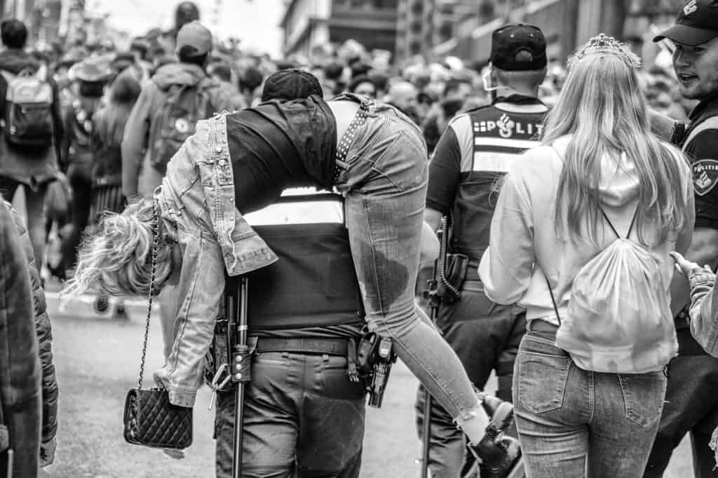 Man carrying his drunk wife after she passed out
