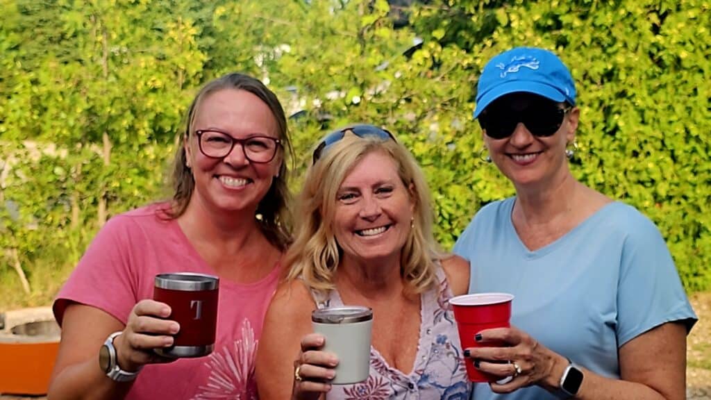 Three women outdoors enjoying Cocktails with Friends