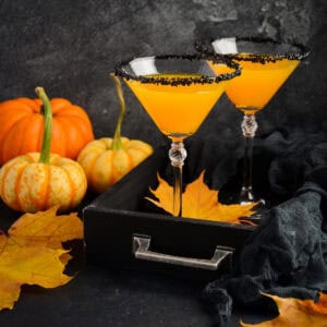 2 Pumpkintini Halloween Cocktails with fall decorations