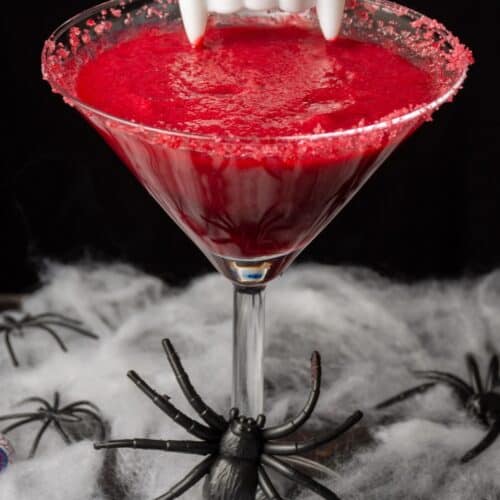 Vampire Kiss Halloween Cocktail with webbing, plastic spiders and eyeballs