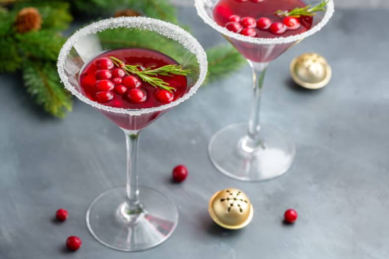 Cocktails and Crafting with this Holiday Merry Maker Martini with cranberries floating in a martini glass.