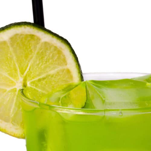 Mary Jane Punch bright green cocktail with a lime wheel