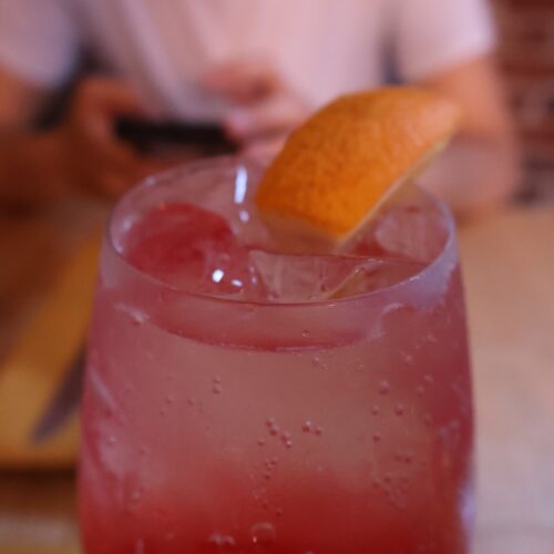Pink Cocktail with a slice of orange on top