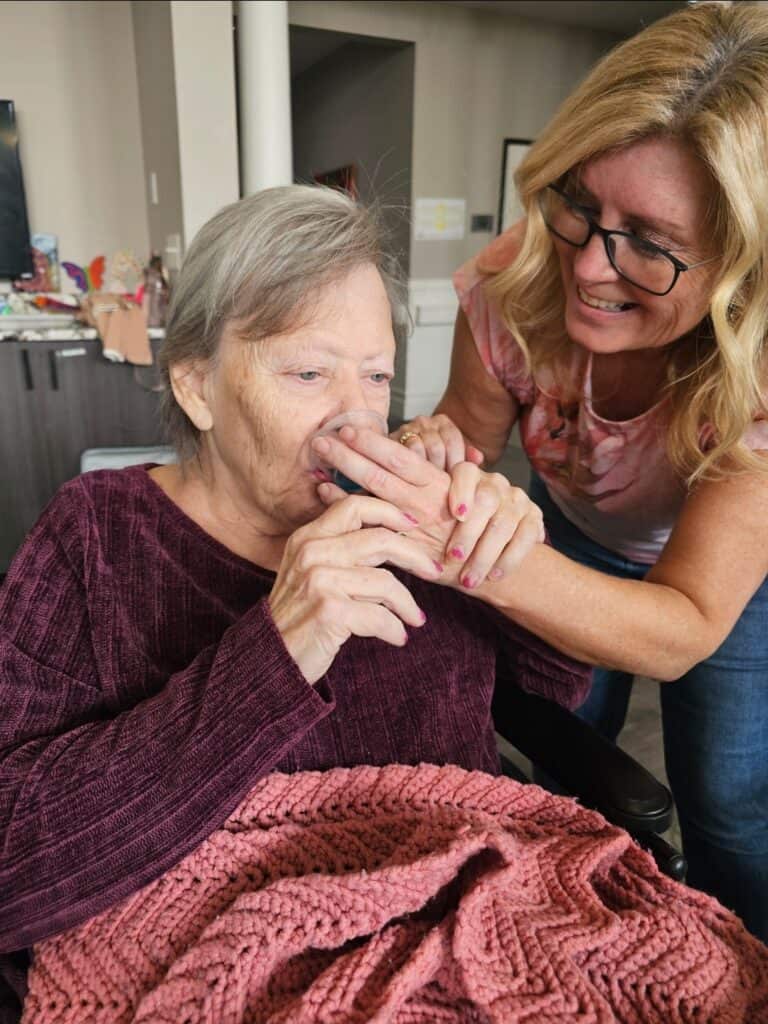 Woman feeding another woman a Mocktail shot