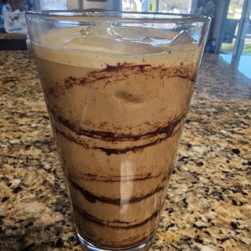 Iced Mocha Coffee with chocolate swirls in a pint glass
