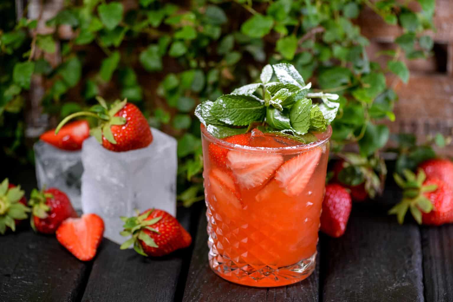 Garden Party Spritz with a background of mint and strawberries